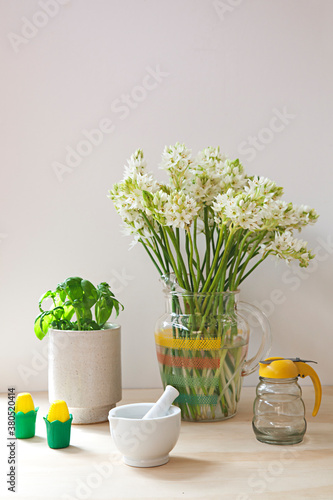 Tableau or kitchen vignette with flowers and basil and utensils photo