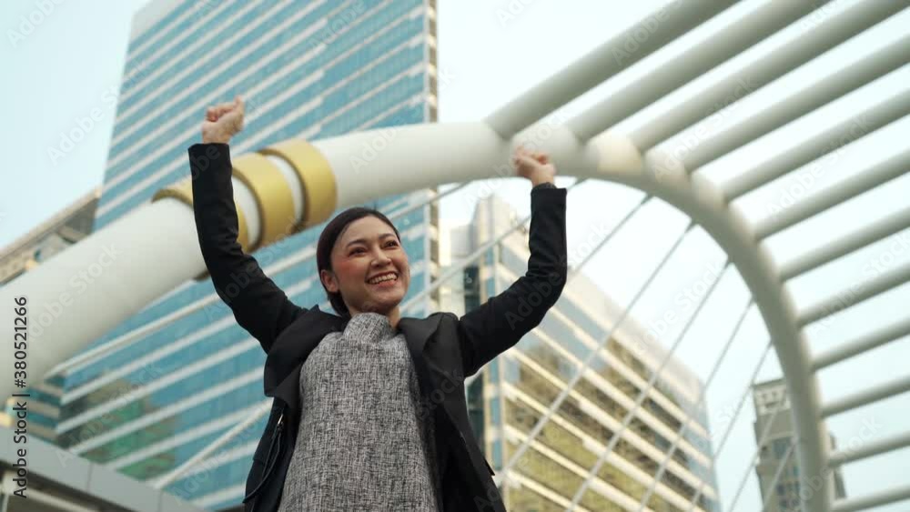 successful business woman with arms raised in the city successful business woman with arms raised in the city