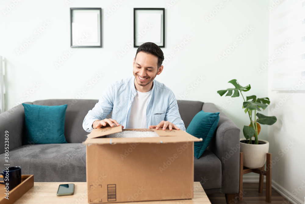 Man opening a package at home Man opening a package at home