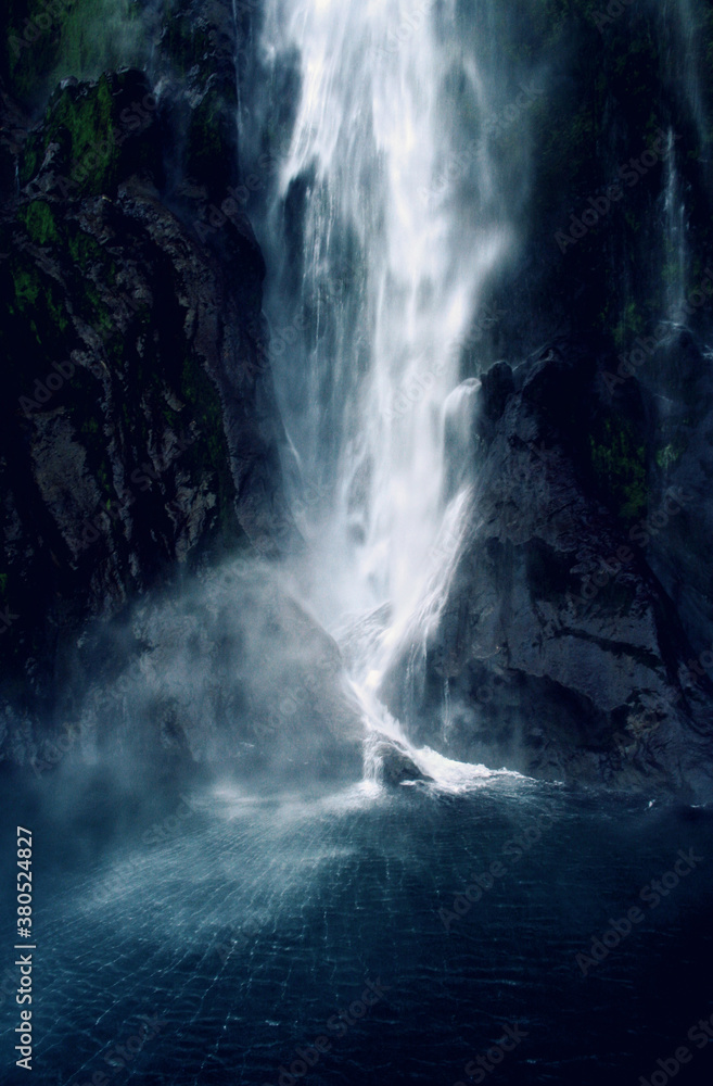Moody, gushing waterfall in New Zealand's fjord (sound) region. Moody, gushing waterfall in New Zealand's fjord (sound) region.