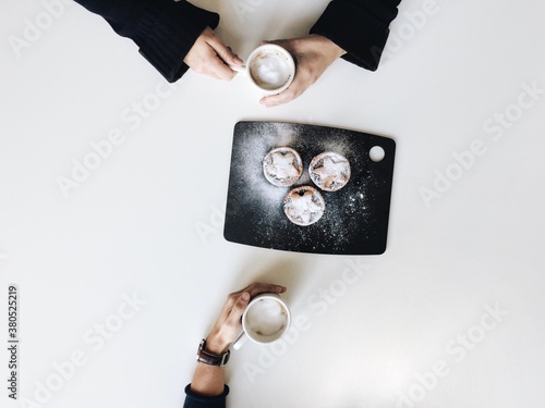 Two friends sharing coffee and some mince pies photo