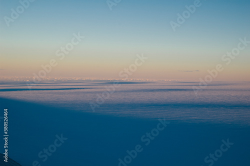 View of the polar plateau with icebergs and sea ice in the distance, Antarctica. photo