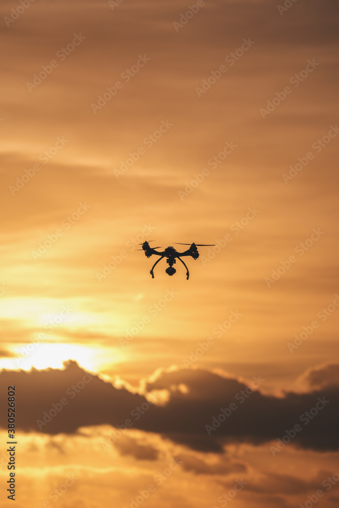 Drone flying in the cloudy sunset Drone flying in the cloudy sunset