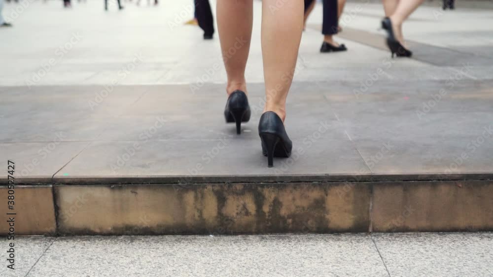 business woman with high heel shoes walking up on the stairs in the city business woman with high heel shoes walking up on the stairs in the city