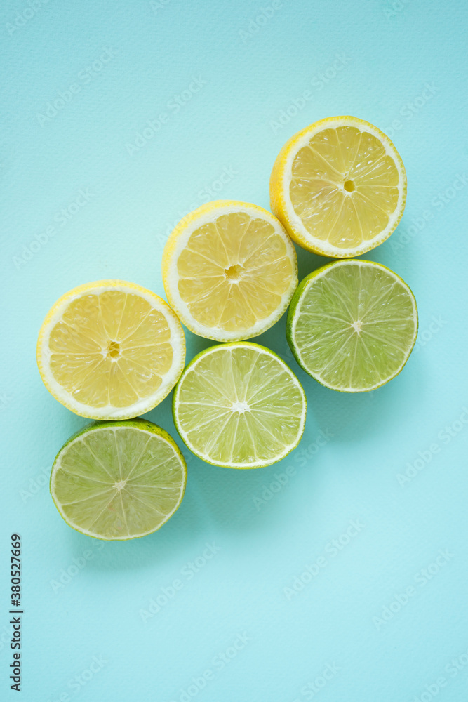 Lemons and limes on a pastel blue background Lemons and limes on a pastel blue background