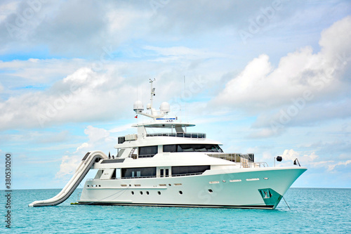 Luxury yacht with slide anchored in turquoise waters in the Caribbean sea © Ryan Tishken