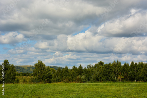 Beautiful summer landscape  green hills  rain clouds in the sky