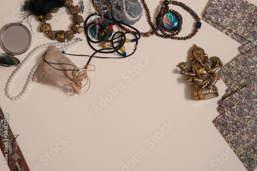 Occult symbols. Aroma stick, Ganesha figurine, stone rosary. 