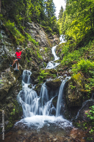 Mountain landscape in Slovakia. Magical forest in natural park .People climbing on steep rock on via ferrata. photo