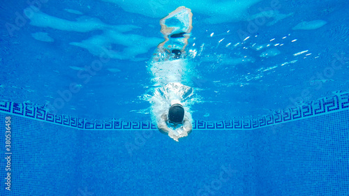 Woman diving into a pool photo