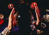 Closeup of fortuneteller's hands on a glass orb. Prediction of the future. Mystic interior