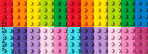 Many toy blocks in different colors making up one large square shape in top view. Toys and games. Leisure and recreation.