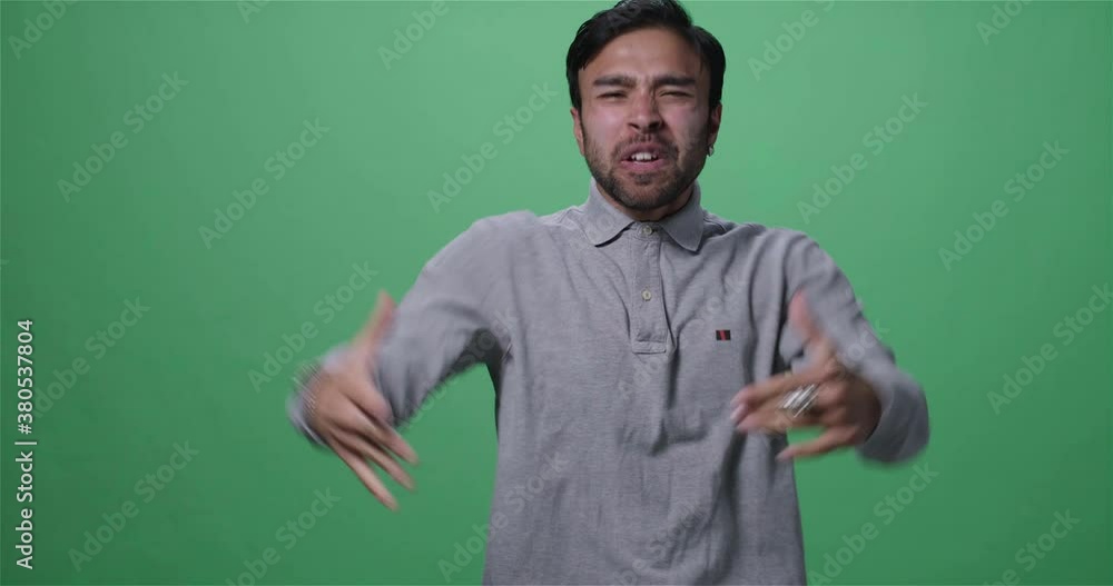 Studio shot of an excited Asian man shouting and gesturing Studio shot of an excited Asian man shouting and gesturing