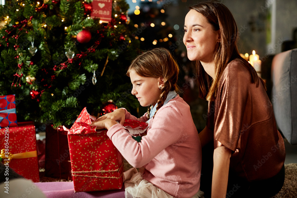 Mother With Daughter Opening Christmas Gift At Home Mother With Daughter Opening Christmas Gift At Home