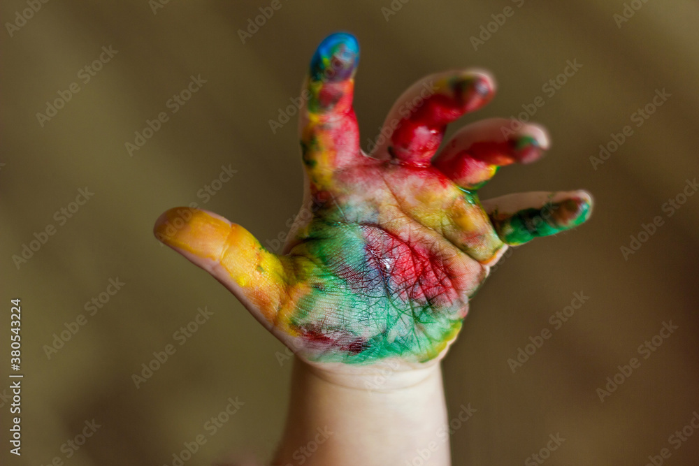 Fototapeta premium Child hands painted in colorful paints.