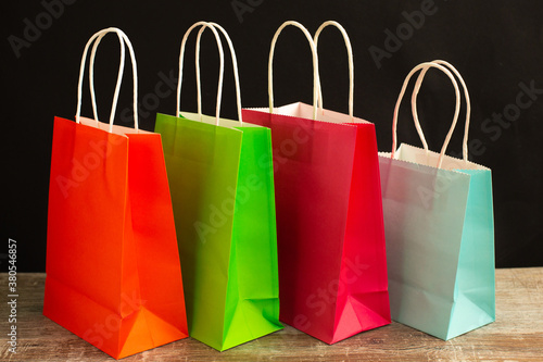 Many colorful shopping bags on black background