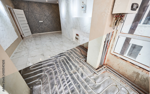 Comparison of new renovated apartment with marble floor and old place with underfloor heating pipes. Modern apartment room before and after refurbishment. Concept of home renovation.