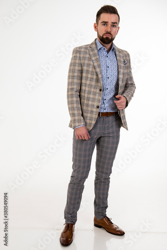 Fashionable man in festive clothes posing on white background 