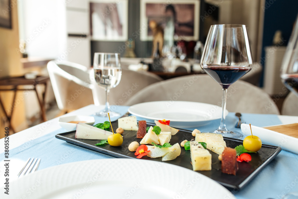 Assorted spanish cheese platter with red wine