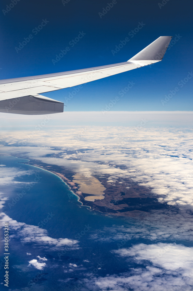 Airplane wing over the coast of Australia through an airplane window Airplane wing over the coast of Australia through an airplane window