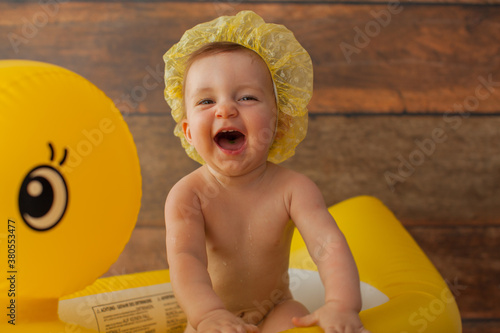 фотографія One year old baby girl takes a bath