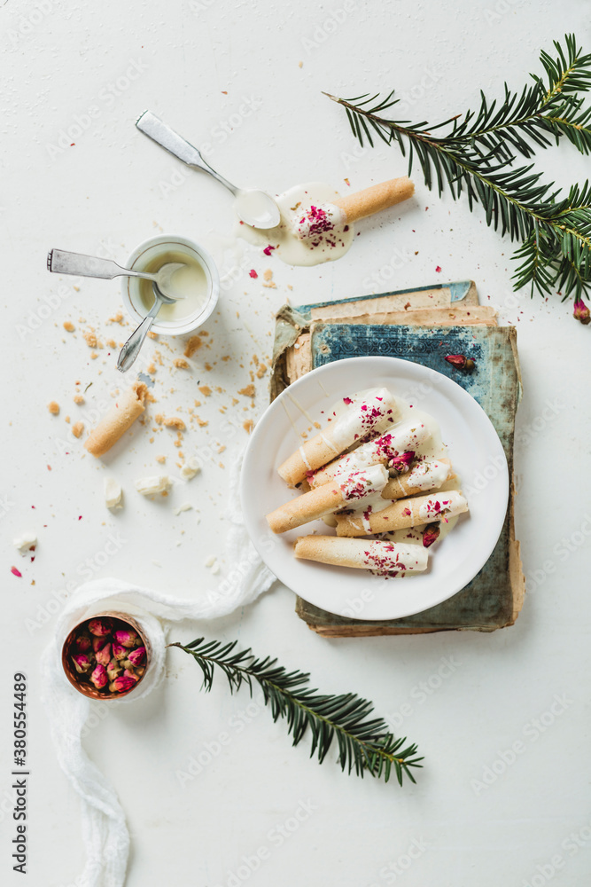 Cigarette cookies with white chocolate and rose buds Cigarette cookies with white chocolate and rose buds