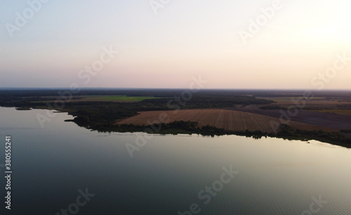 Top view of a calm large forest lake © Payllik
