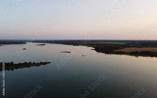 Top view of a calm large forest lake © Payllik