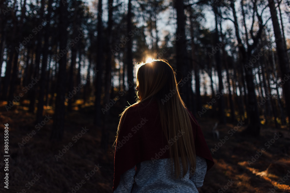 Back portrait of blond woman in the forest Back portrait of blond woman in the forest