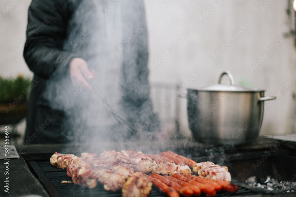 Barbecue and man behind the smoke, just hand