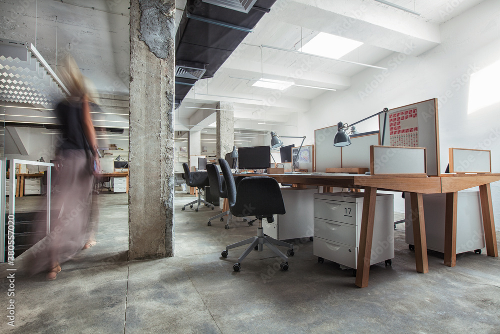 Businesswoman Passing Through a Modern Office Businesswoman Passing Through a Modern Office