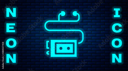 Glowing neon Museum audio guide icon isolated on brick wall background. Headphones for excursions. Vector.