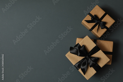 Craft gift boxes with bow on gray background © Atlas