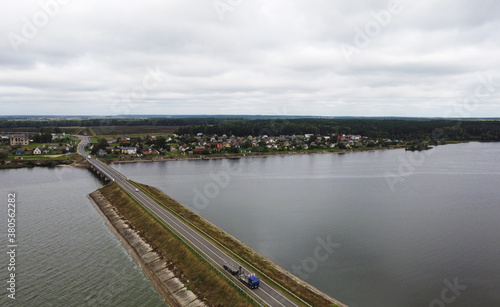 Wallpaper Mural Top view of the road bridge dam over a huge forest lake Torontodigital.ca
