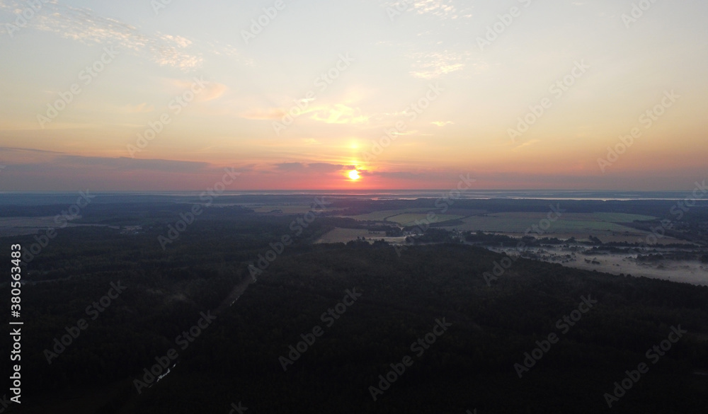 Top view at sunrise on a calm lake and forest Top view at sunrise on a calm lake and forest