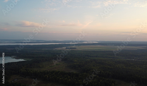 Top view at sunrise on a calm lake and forest