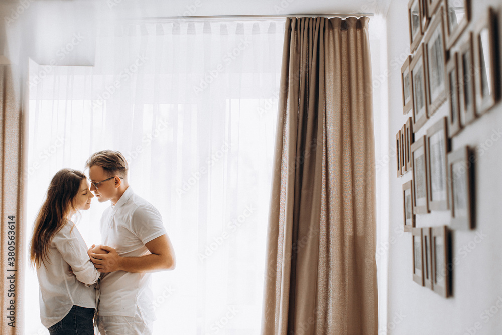 Lovely young parents with newborn baby at home, loving mother and caring father gently hold little daughter in arms, enjoy tender moments, happy family concept Lovely young parents with newborn baby at home, loving mother and caring father gently hold little daughter in arms, enjoy tender moments, happy family concept