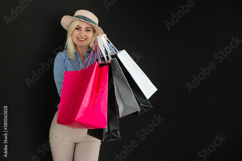Shopping woman holding bags, isolated on black background. black friday concept