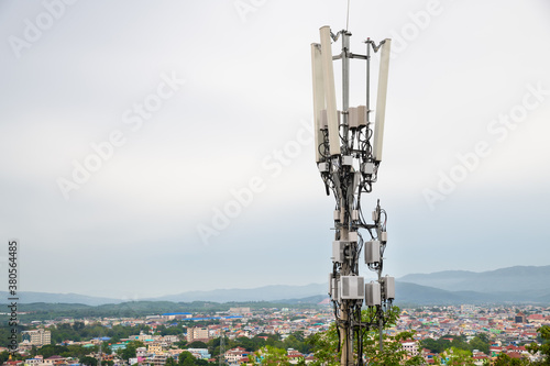Telecommunication tower with 5G cellular network antenna on A town in the valley background