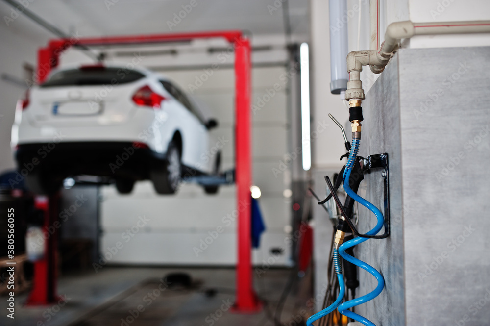 Car lifting in maintenance at garage service station. Car lifting in maintenance at garage service station.