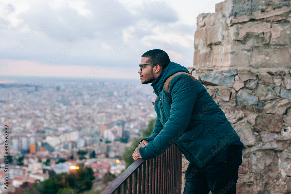Side view of a man standing above city on winter. Side view of a man standing above city on winter.