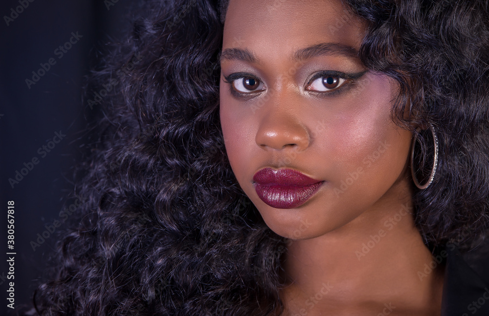 Extreme close-up of beautiful young African model with curly long hair and red full lips Extreme close-up of beautiful young African model with curly long hair and red full lips