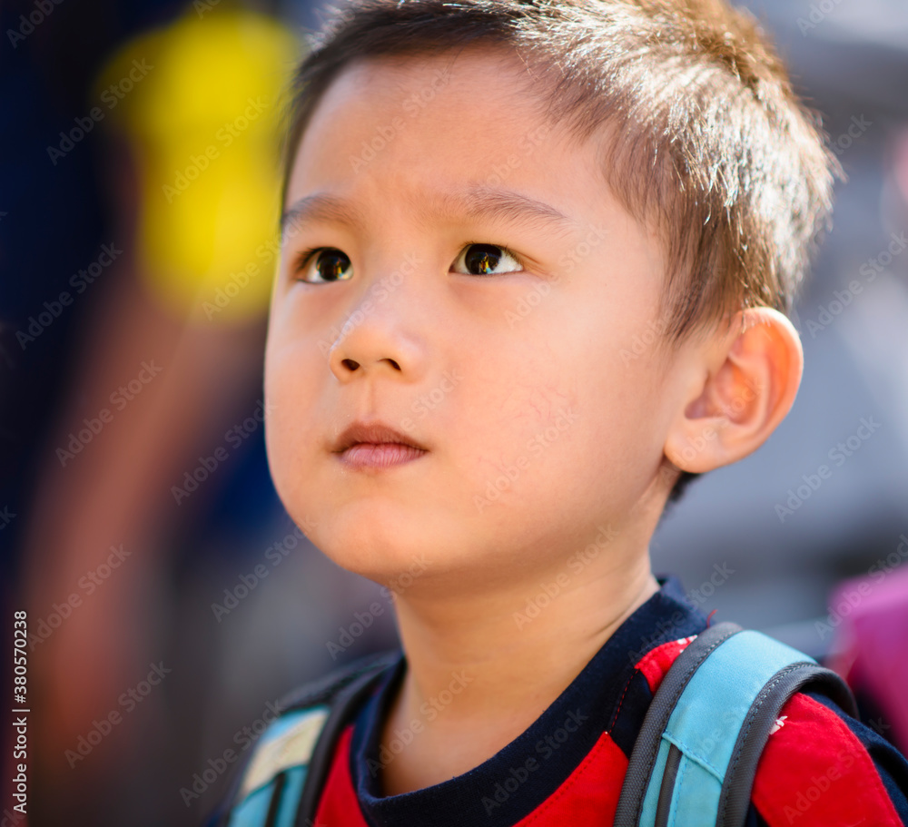 Child looking up with serious face Stock Photo | Adobe Stock
