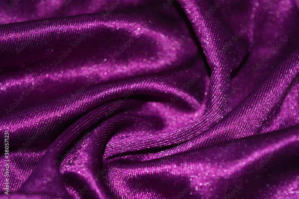 Bright colorful, rich velvet purple background with overflow and ebb. An unusual shaggy purple fabric with curves and waves is located on a flat surface, an unusual look. Bright colorful, rich velvet purple background with overflow and ebb. An unusual shaggy purple fabric with curves and waves is located on a flat surface, an unusual look.