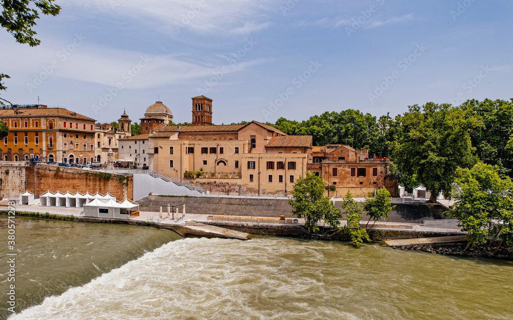 Rome Italy, scenic view of vintage buildings onTiber island and the river banks with trees