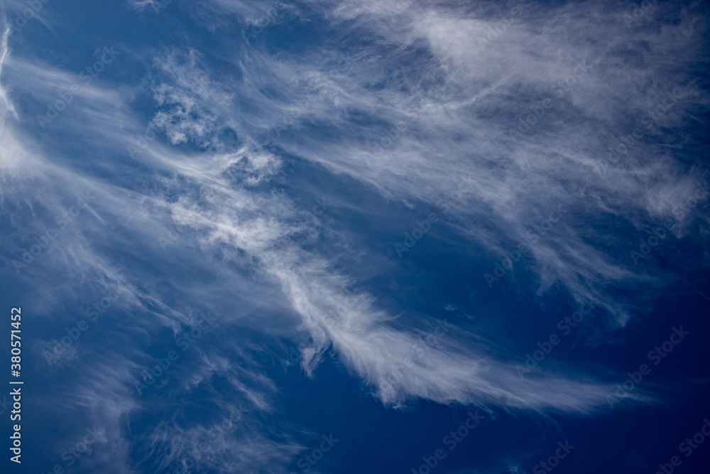 blue sky with white wispy clouds in the background blue sky with white wispy clouds in the background