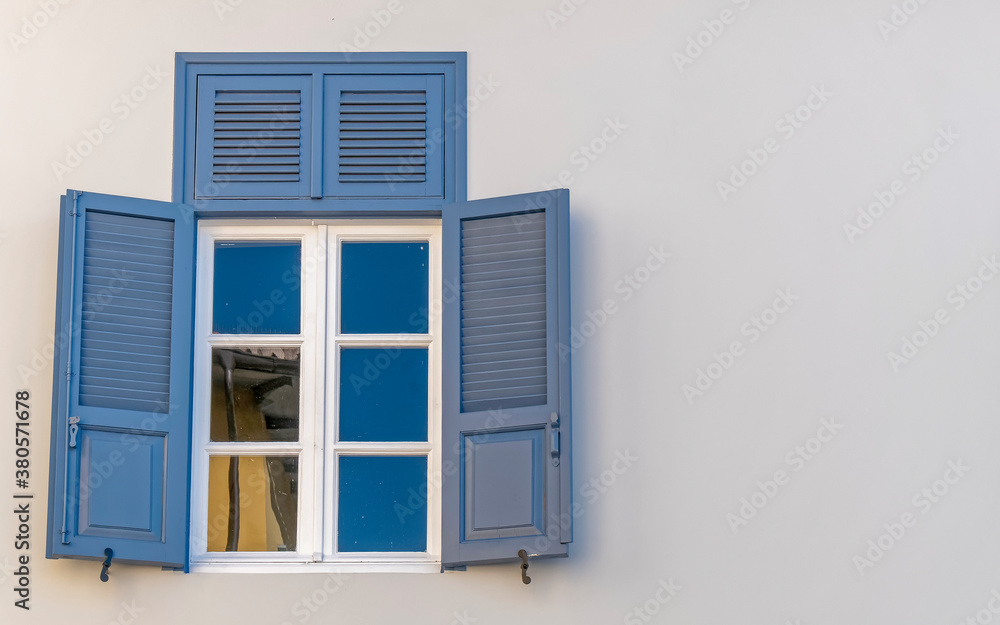 Fototapeta premium vintage blue shutters with white frame window, space for text