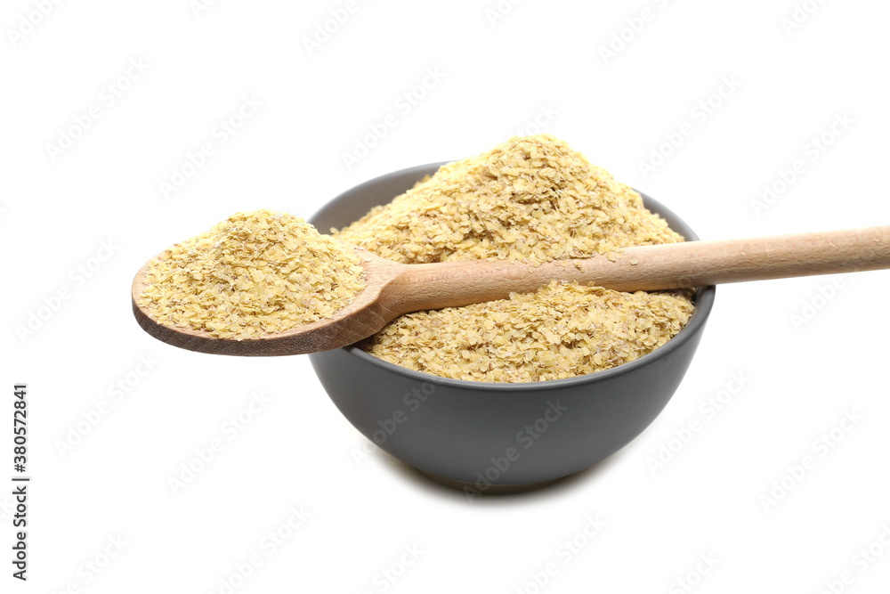 Wheat germ pile in porcelain bowl with wooden spoon isolated on white background Wheat germ pile in porcelain bowl with wooden spoon isolated on white background
