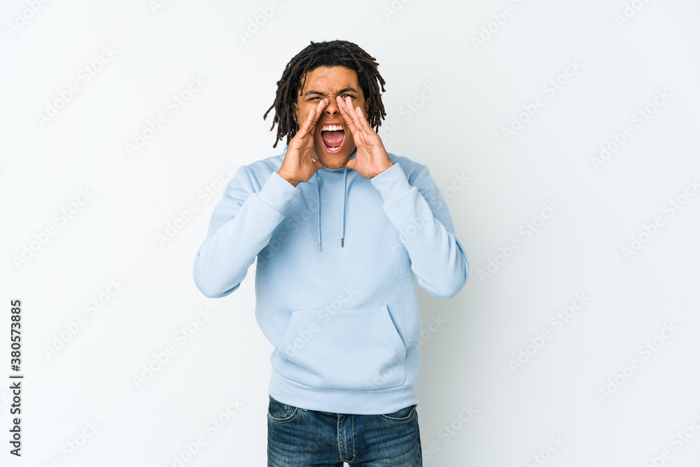 Young african american rasta man shouting excited to front. Young african american rasta man shouting excited to front.