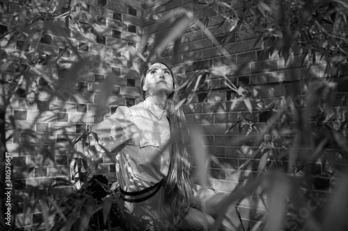 Black and white portrait of a mysterious young woman looking up in a bamboo grove photo